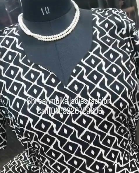 Black and white printed one-piece dress with wrap V neckline on a mannequin at Shree Ambika, Virar West